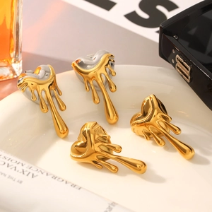 Lava-style heart earrings in gold and silver finish displayed on a white tray