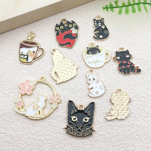 Detailed view of mixed cartoon cat enamel pendants for creative DIY jewelry making