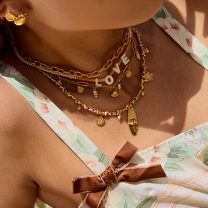 Layered gold necklace with pearls, LOVE beads and colorful woven rope bohemian pendants