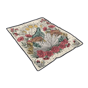 Macro shot of flannel throw blanket with vintage mystical moon, moths and floral graphics