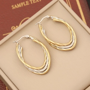Two-tone intertwined geometric oval hoop earrings in gold and silver finish