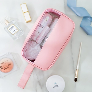 Pink PU leather makeup bag with transparent PVC window showing spacious storage