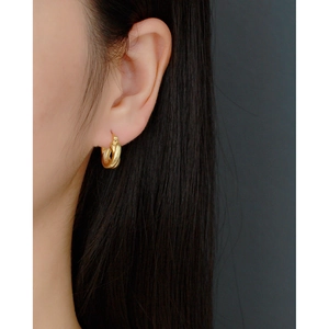 French style S925 sterling silver golden twisted cross earrings worn by model on dark background