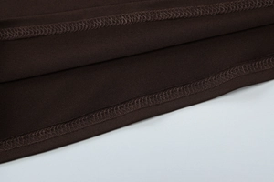 Detail view of the high-quality double-stitch hem and fabric texture of the brown summer set