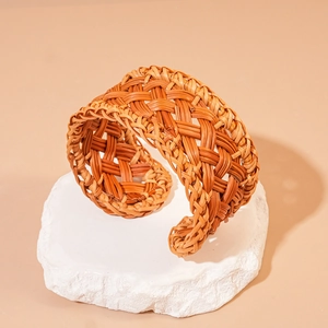Handcrafted woven rattan open bangle with geometric mesh design in natural wood finish