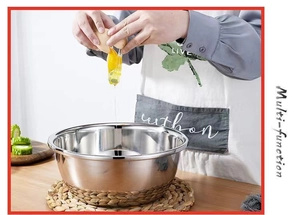 Multi-function stainless steel basin being used for mixing eggs in a kitchen setting