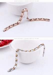 Detailed view of rose gold and silver-gold link bracelets set with sparkling crystals