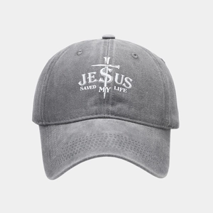 Macro detail of washed gray baseball cap featuring Jesus Saved My Life cross embroidery
