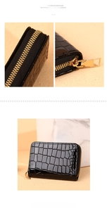 Close-up of black crocodile texture card holder with premium gold metal zipper detail