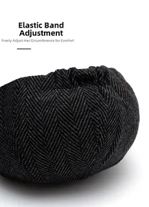 Detail of adjustable elastic band on black herringbone newsboy cap for custom fit