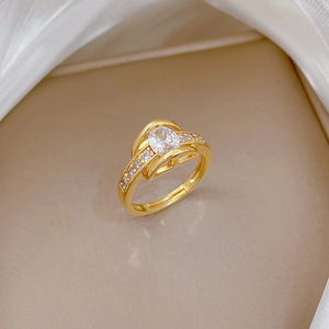 Adjustable gold ring featuring oval marquise cubic zirconia with an H-shaped open design