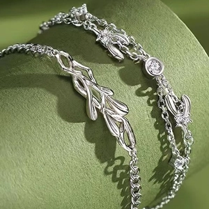 Macro shot of silver mistletoe leaf bracelet with sparkling zircon stones inlay