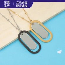 Polished oval stainless steel pendant necklaces in black and gold on a textured background