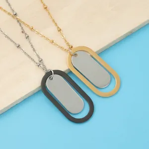 Polished oval stainless steel pendant necklaces in black and gold on a textured background