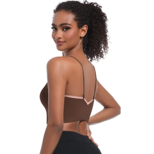 Detail of cross straps and pink V-shaped edging on the seamless brown yoga bra