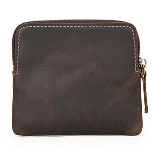 Detailed view of brown crazy horse leather texture and stitching on a vintage coin purse