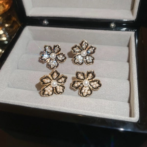 Vintage small flower stud earrings with faux pearls and rhinestones in a gray velvet box