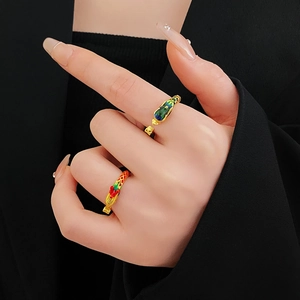 Close-up of enamel dragon and phoenix open rings in gold finish worn on fingers