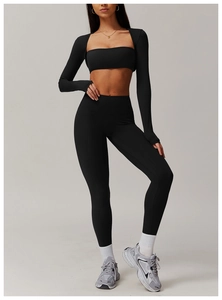 Three-piece black yoga set with zip-up long sleeve crop top, sports bra, and high-waist leggings