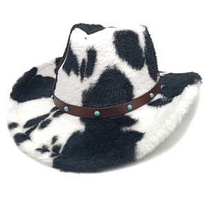 Detail of plush cow print cowboy hat featuring brown leather band with turquoise beads