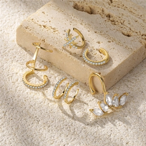 Detailed close-up of 5 gold-plated S925 silver ear cuffs with clear cubic zirconia accents