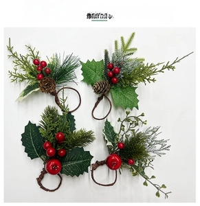 Detailed macro view of four Christmas napkin rings with pine needles and red berries