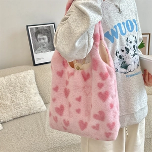 Detail view of pink plush tote bag showing soft fuzzy texture and magnetic buckle closure