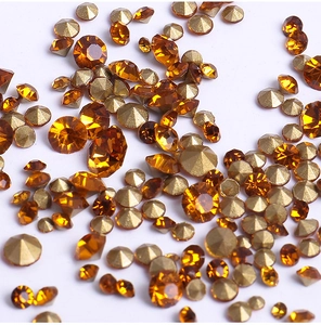 Macro shot of assorted amber crystal rhinestones for nail art and DIY jewelry