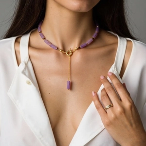 Purple amethyst beaded necklace with gold OT toggle clasp and pendant on white shirt