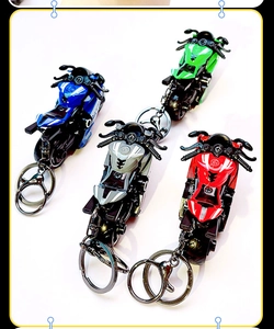 Detail view of colorful mini motorcycle model keychains in red, blue, green and silver