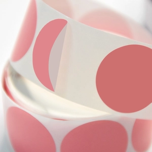 Pink round colored dot labels roll for sealing and organizing with one sticker peeling off