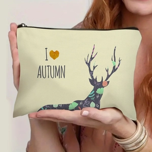 Portable beige canvas toiletry bag with autumn elk print and black zipper closure