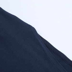 Detailed close-up of stitching and seam quality on a navy blue knit dress fabric