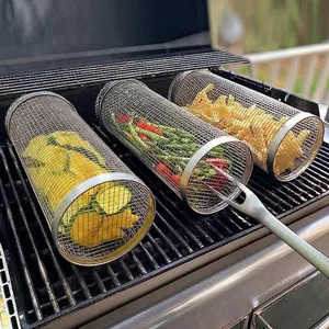 Three stainless steel rolling grilling baskets with vegetables on a barbecue grill rack