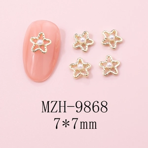Detail of 7x7mm star-shaped nail charms with pearls on pink background