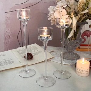 Three-piece set of elegant glass candle holders with tea lights for romantic dinners