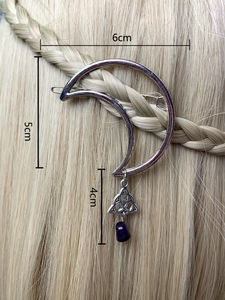 Silver crescent moon hair clip with purple stone and Celtic knot on golden braided hair
