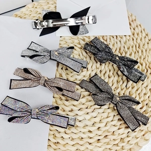 Detail of crystal rhinestone bow hair clips in various colors with metallic back spring clips