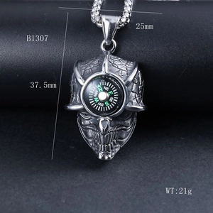 Macro view of vintage silver skull compass pendant with dimensions 37.5mm by 25mm