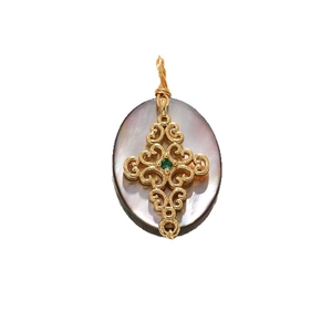 Vintage oval shell pendant with gold cross and green gemstone on white background