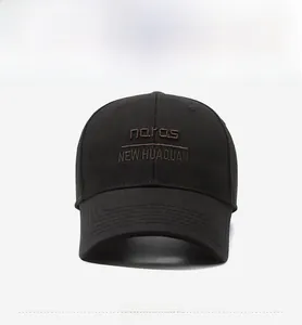 Detail of black cotton baseball cap with brown 3D embroidery and reinforced stitching