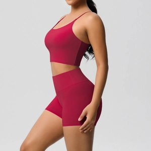 Detail view of red yoga set showing slim straps and high-waisted fitness shorts