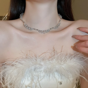 Lace diamond geometric necklace in silver finish worn by model with feather accent