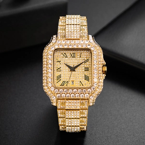 Macro detail of gold square iced-out watch showing Roman numerals and date display