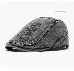 Detail of washed black denim ivy cap with vintage distressed embroidery and ripped effects