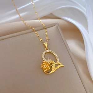 Macro view of luxurious heart pendant with 3D rose and cubic zirconia on gold chain