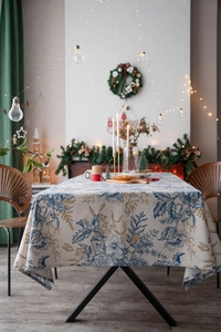 Detailed texture of cotton linen tablecloth featuring festive pine branch and flower prints