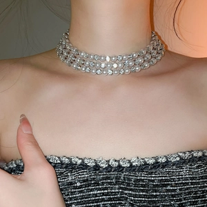 Detail of multi-layer choker featuring white pearls and sparkling rhinestone accents