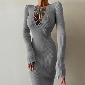 Detailed view of grey rib-knit dress featuring slim fit and cross strap neck detail