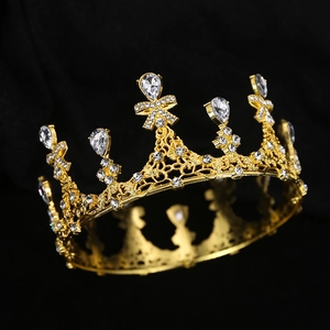 Detailed view of vintage gold bridal crown with hollow engraving and sparkling rhinestones